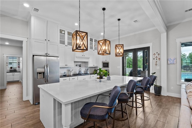1909 Bareboot Trl, College Station, TX 77845 - kitchen with appliances with stainless steel finishes, french doors, wood finished floors, healthy amount of natural light, and recessed lighting