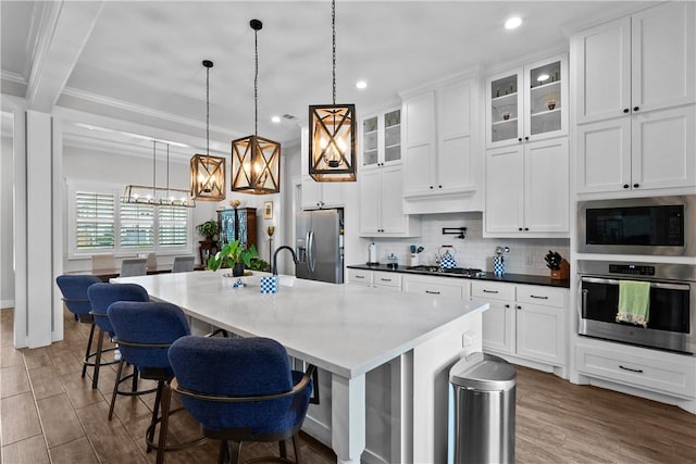 1909 Bareboot Trl, College Station, TX 77845 - kitchen featuring stainless steel appliances, a chandelier, recessed lighting, decorative backsplash, and white cabinets