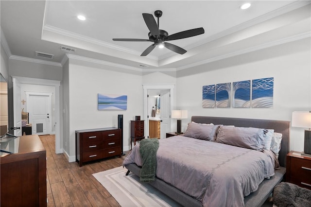 1909 Bareboot Trl, College Station, TX 77845 - bedroom featuring a tray ceiling, dark wood-style floors, ornamental molding, recessed lighting, and a ceiling fan