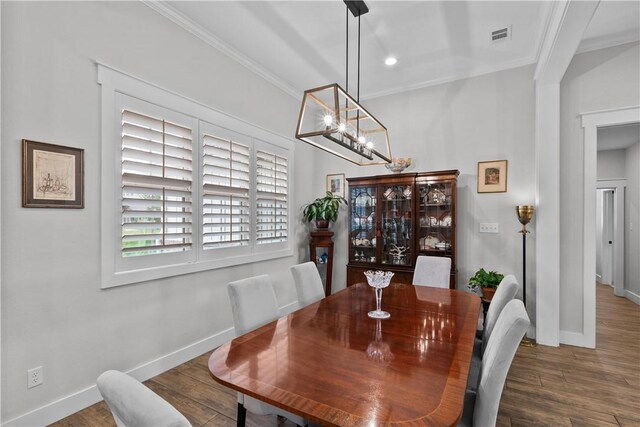 1909 Bareboot Trl, College Station, TX 77845 - dining room with crown molding, a chandelier, and wood finished floors