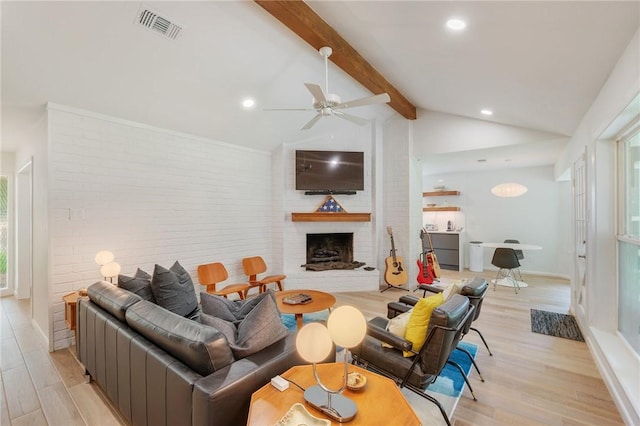 1003 Guadalupe Dr, College Station, TX 77840 - living area with a ceiling fan, light wood finished floors, a brick fireplace, recessed lighting, and brick wall