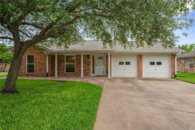 1003 Guadalupe Dr, College Station, TX 77840 - single story home featuring concrete driveway, a front lawn, brick siding, and a garage