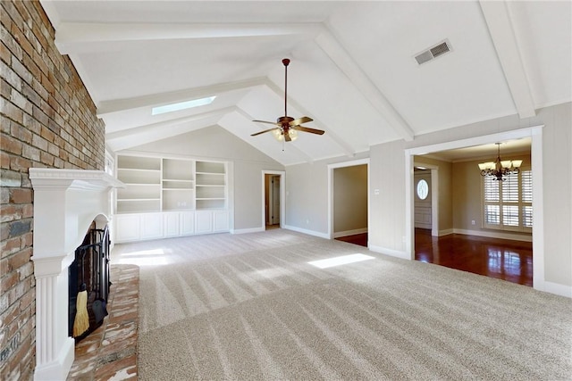 unfurnished living room featuring carpet floors, visible vents, a fireplace, and lofted ceiling with skylight