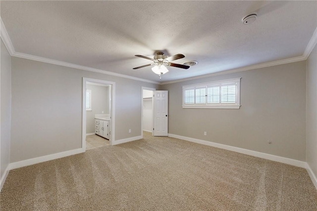 unfurnished bedroom with light carpet, baseboards, visible vents, ornamental molding, and a textured ceiling