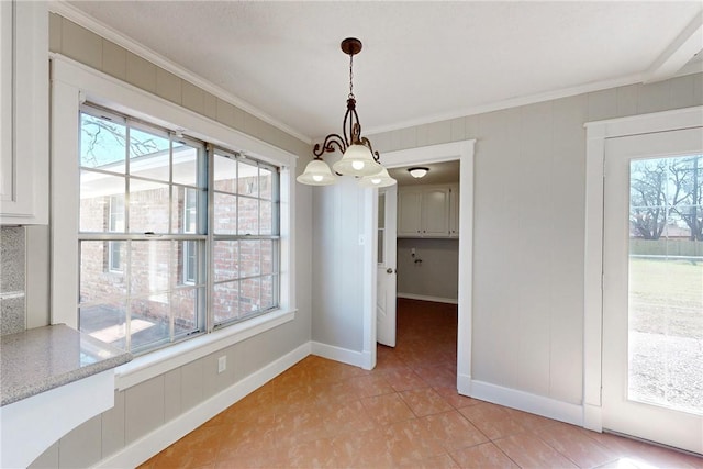 unfurnished dining area featuring light tile patterned floors, crown molding, baseboards, and an inviting chandelier