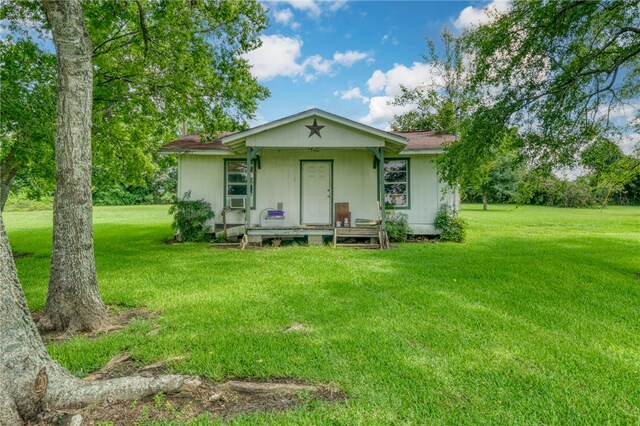 back of house with a lawn