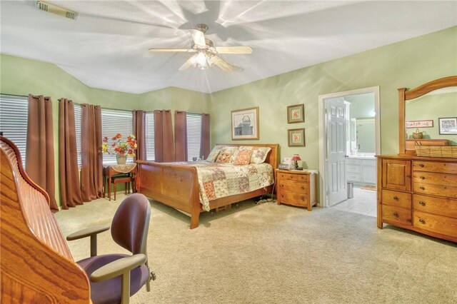 bedroom with ensuite bathroom, ceiling fan, and light carpet