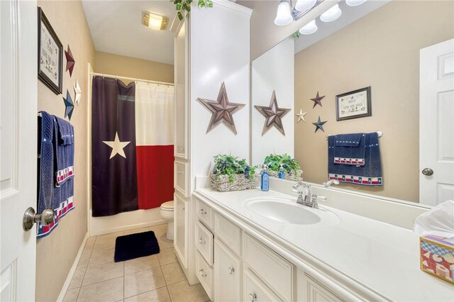 bathroom featuring tile patterned flooring, vanity, and toilet