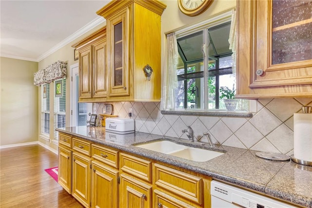 kitchen with sink, backsplash, white dishwasher, light hardwood / wood-style floors, and ornamental molding