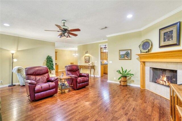 living room with a fireplace, wood-type flooring, and ornamental molding