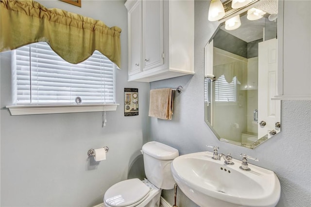 bathroom with a shower, toilet, and sink