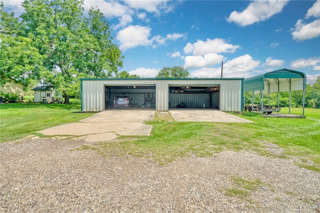 garage with a carport and a yard