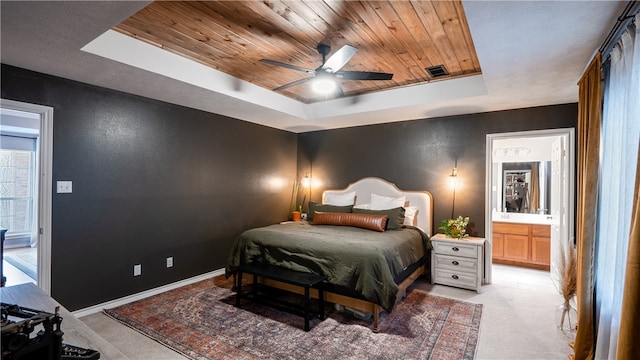 bedroom with baseboards, ceiling fan, light colored carpet, a tray ceiling, and wooden ceiling