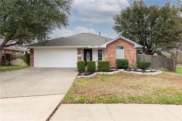 ranch-style home featuring brick siding, concrete driveway, a front yard, and fence