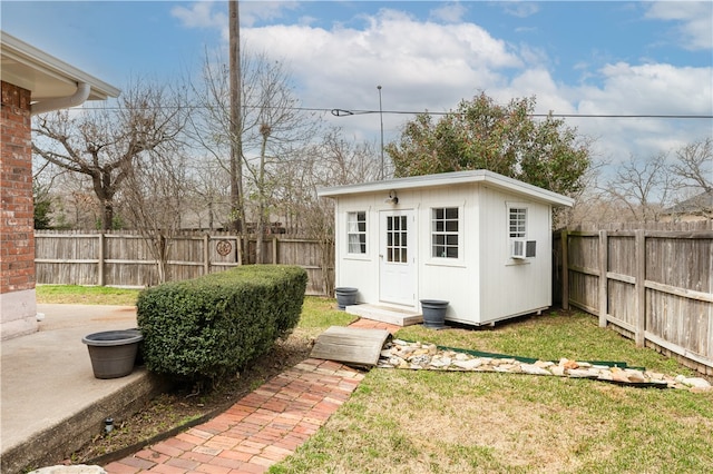 view of outbuilding featuring cooling unit, an outdoor structure, and a fenced backyard