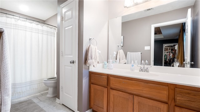 bathroom featuring tile patterned floors, visible vents, toilet, a closet, and vanity