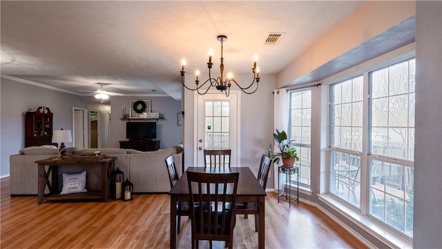 dining space with baseboards, a healthy amount of sunlight, visible vents, and light wood-type flooring