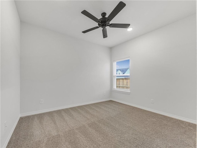 carpeted empty room featuring ceiling fan