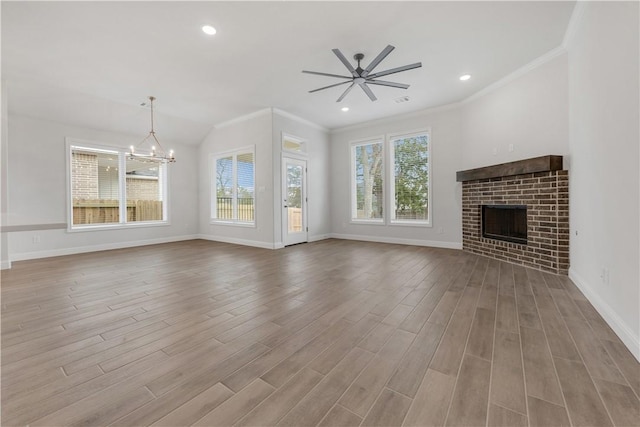 unfurnished living room with a fireplace, a wealth of natural light, and light hardwood / wood-style flooring