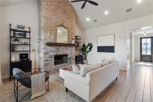 4209 Harding Ct, Bryan, TX 77802 - living area featuring ceiling fan, a fireplace, high vaulted ceiling, wood finish floors, and baseboards
