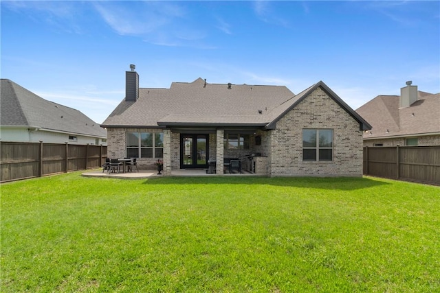 4209 Harding Ct, Bryan, TX 77802 - rear view of house featuring brick siding, french doors, a patio area, and a chimney