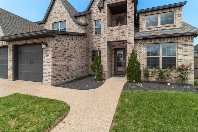 4209 Harding Ct, Bryan, TX 77802 - view of front facade with brick siding, an attached garage, driveway, and a front lawn