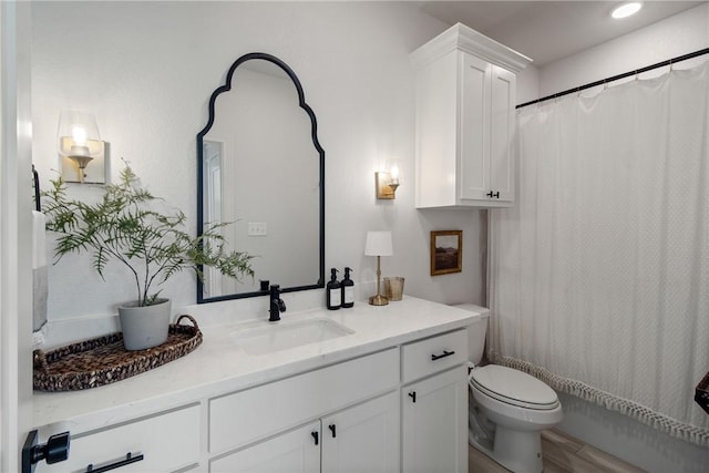 4209 Harding Ct, Bryan, TX 77802 - full bath with toilet, vanity, wood finished floors, and a shower with shower curtain