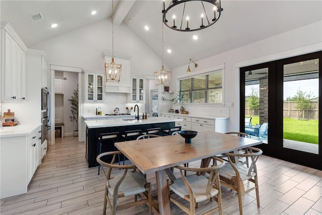 4209 Harding Ct, Bryan, TX 77802 - dining room with a chandelier, beamed ceiling, high vaulted ceiling, french doors, and recessed lighting