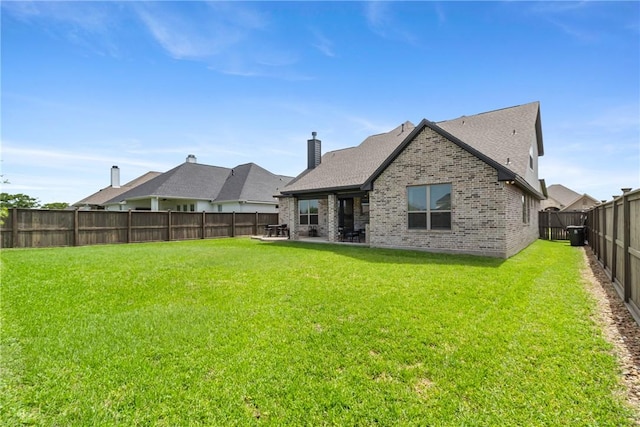 4209 Harding Ct, Bryan, TX 77802 - rear view of property featuring brick siding, a chimney, and a patio