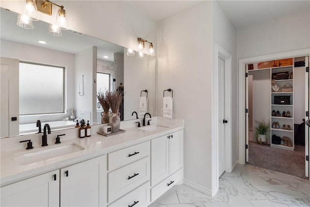 4209 Harding Ct, Bryan, TX 77802 - bathroom with marble finish flooring, double vanity, and a spacious closet