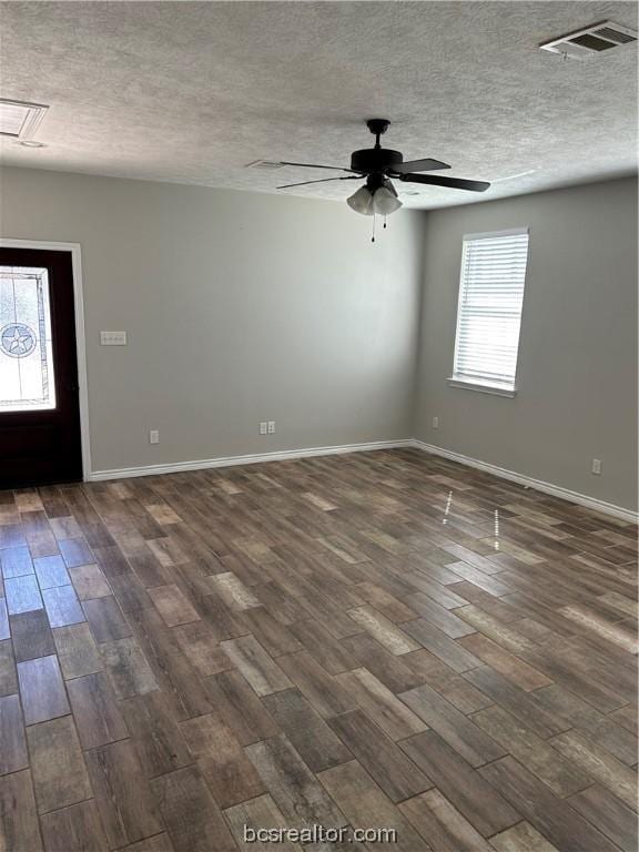 foyer entrance featuring a textured ceiling, dark hardwood / wood-style floors, and ceiling fan