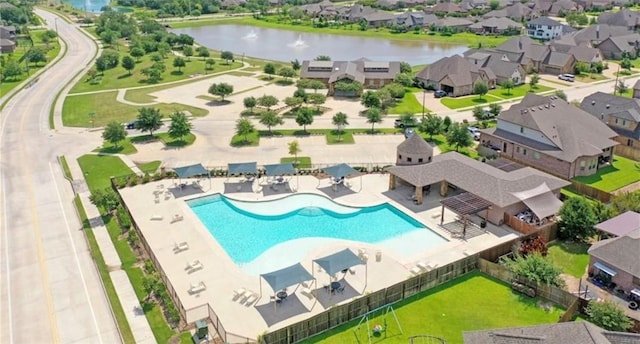 birds eye view of property with a water view and a residential view