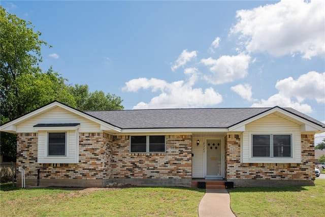 2323 Carter Creek Pkwy, Bryan, TX 77802 - single story home featuring brick siding, a front yard, and roof with shingles