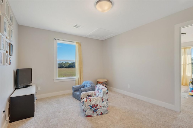 living area featuring light carpet