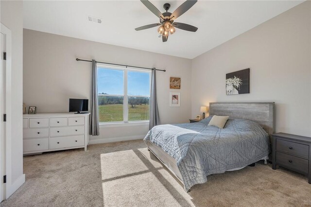 bedroom featuring light colored carpet and ceiling fan