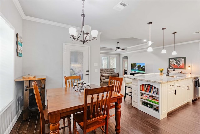 dining area featuring arched walkways, ceiling fan with notable chandelier, visible vents, dark wood finished floors, and crown molding