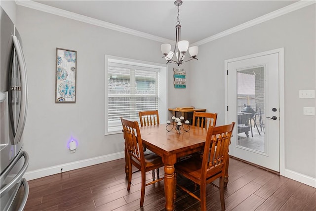 dining room featuring an inviting chandelier, baseboards, ornamental molding, and dark wood-type flooring