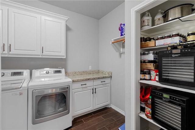 washroom with cabinet space, baseboards, washer and dryer, and wood finish floors