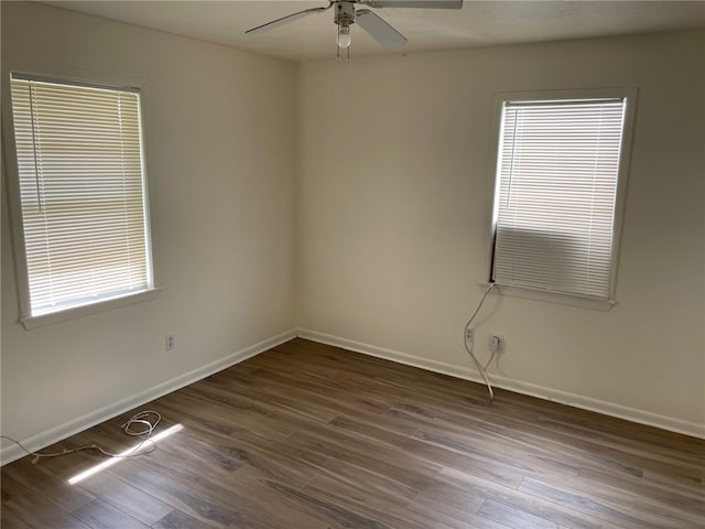 empty room with dark hardwood / wood-style floors and ceiling fan