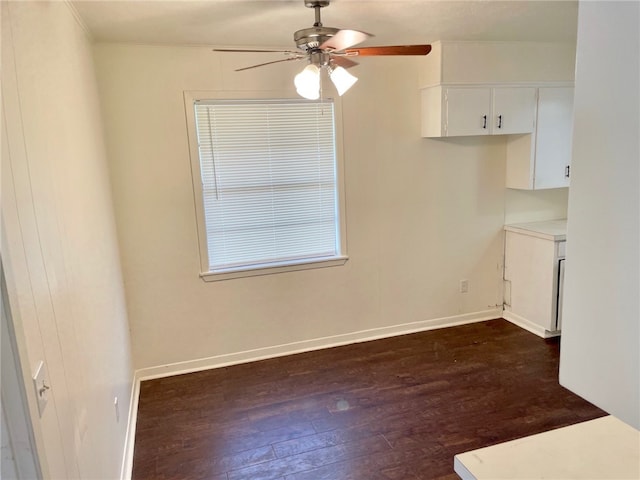 unfurnished room with ceiling fan and dark wood-type flooring