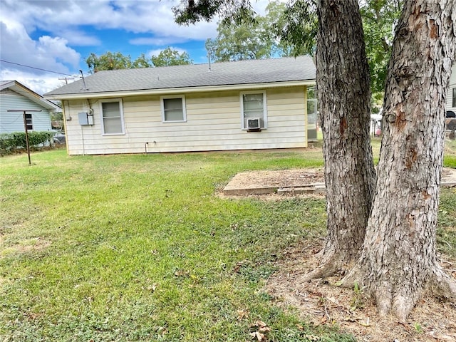 back of property with a lawn and cooling unit