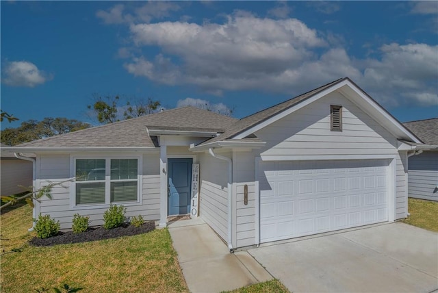 ranch-style house featuring a front lawn, an attached garage, concrete driveway, and roof with shingles