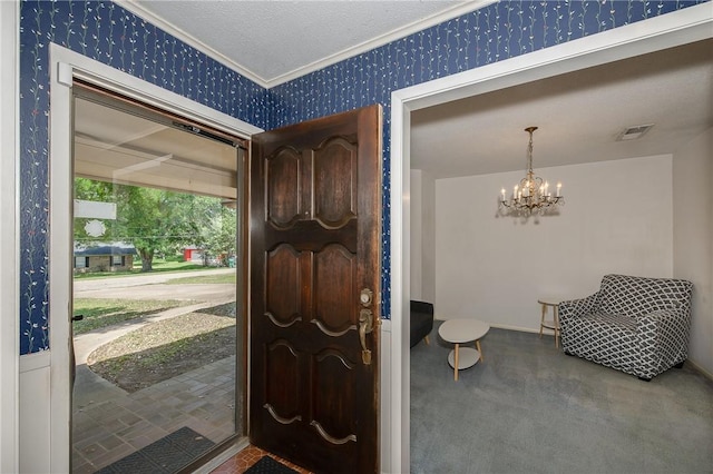 carpeted foyer entrance featuring wallpapered walls, visible vents, crown molding, and an inviting chandelier