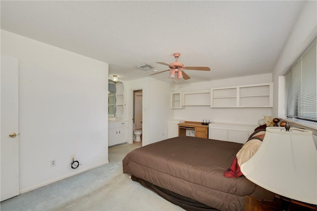 bedroom featuring a ceiling fan, connected bathroom, light carpet, baseboards, and visible vents