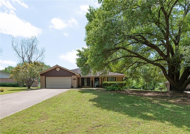 single story home featuring a garage, a front lawn, and concrete driveway