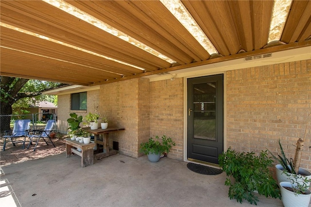 view of patio featuring visible vents and fence