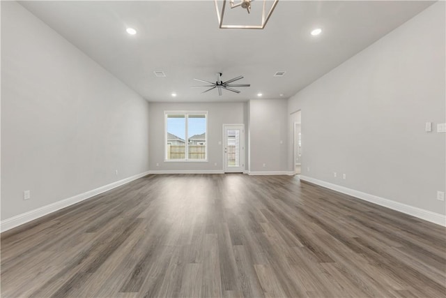 unfurnished living room with recessed lighting, baseboards, and wood finished floors