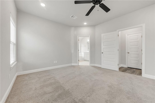 unfurnished bedroom with recessed lighting, visible vents, carpet floors, and ensuite bathroom