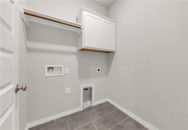 laundry room with hookup for a washing machine, baseboards, cabinet space, electric dryer hookup, and dark tile patterned floors