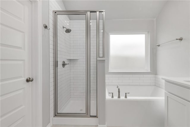 full bath with a bath, a stall shower, and vanity